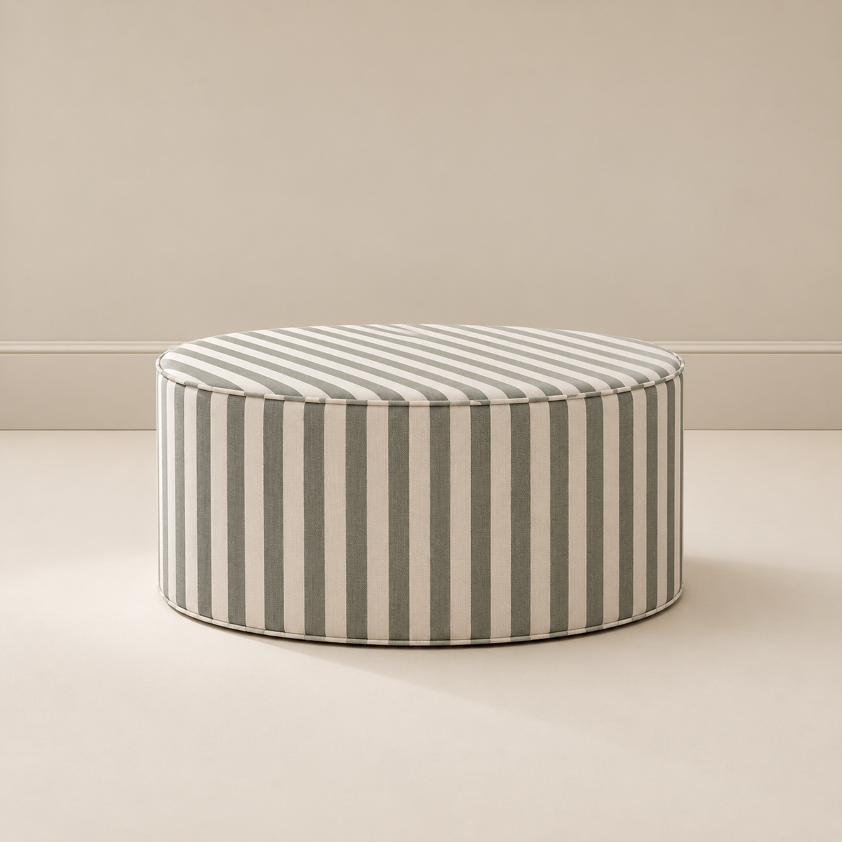 Totem Ottoman in mulled basil stripe, a round striped ottoman that doubles as a footrest, seat or play surface