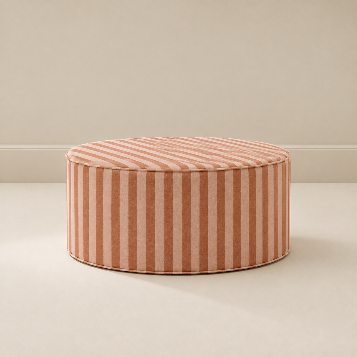 Totem Ottoman in gingerbread stripe, a round striped ottoman that doubles as a footrest, seat or play surface